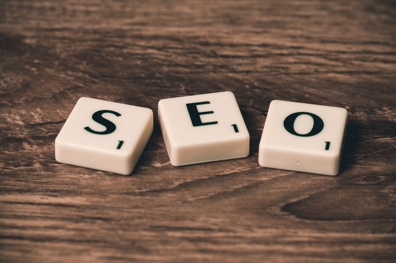services-03 Scrabble tiles spelling SEO on a wooden surface. Ideal for digital marketing themes.